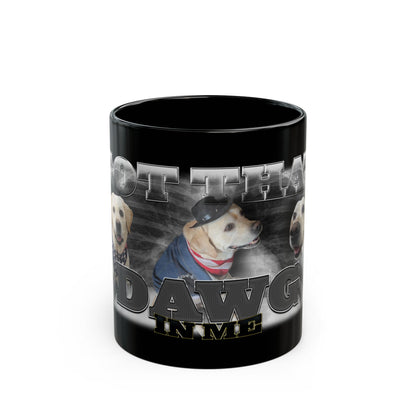 a black coffee mug with a picture of a dog