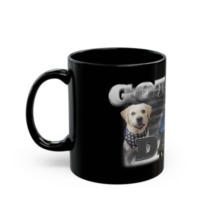 a black coffee mug with a picture of a dog